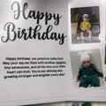 Greeting card with 'Happy Birthday' text and images of a child, featuring the brand 'Framystore'.